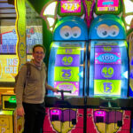 Person playing arcade game machine.