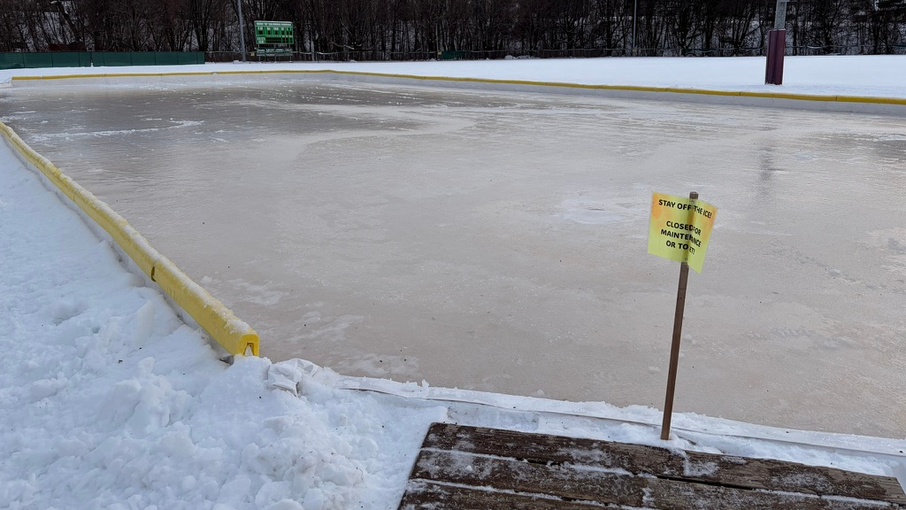 Ice skating rink in Maine with Stay off the Ice sign.