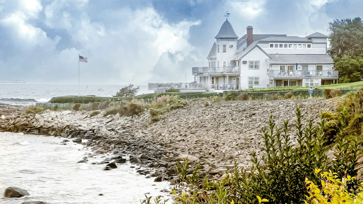 Maine hotel on the water with rocky coastline.